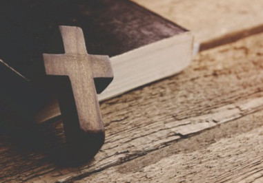 A cross against a bible